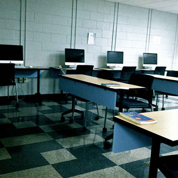 Figure 6 shows a classroom with computer stations around the perimeter and front facing desks in rows in the center